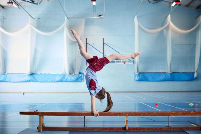 child doing acrobatics on a bench