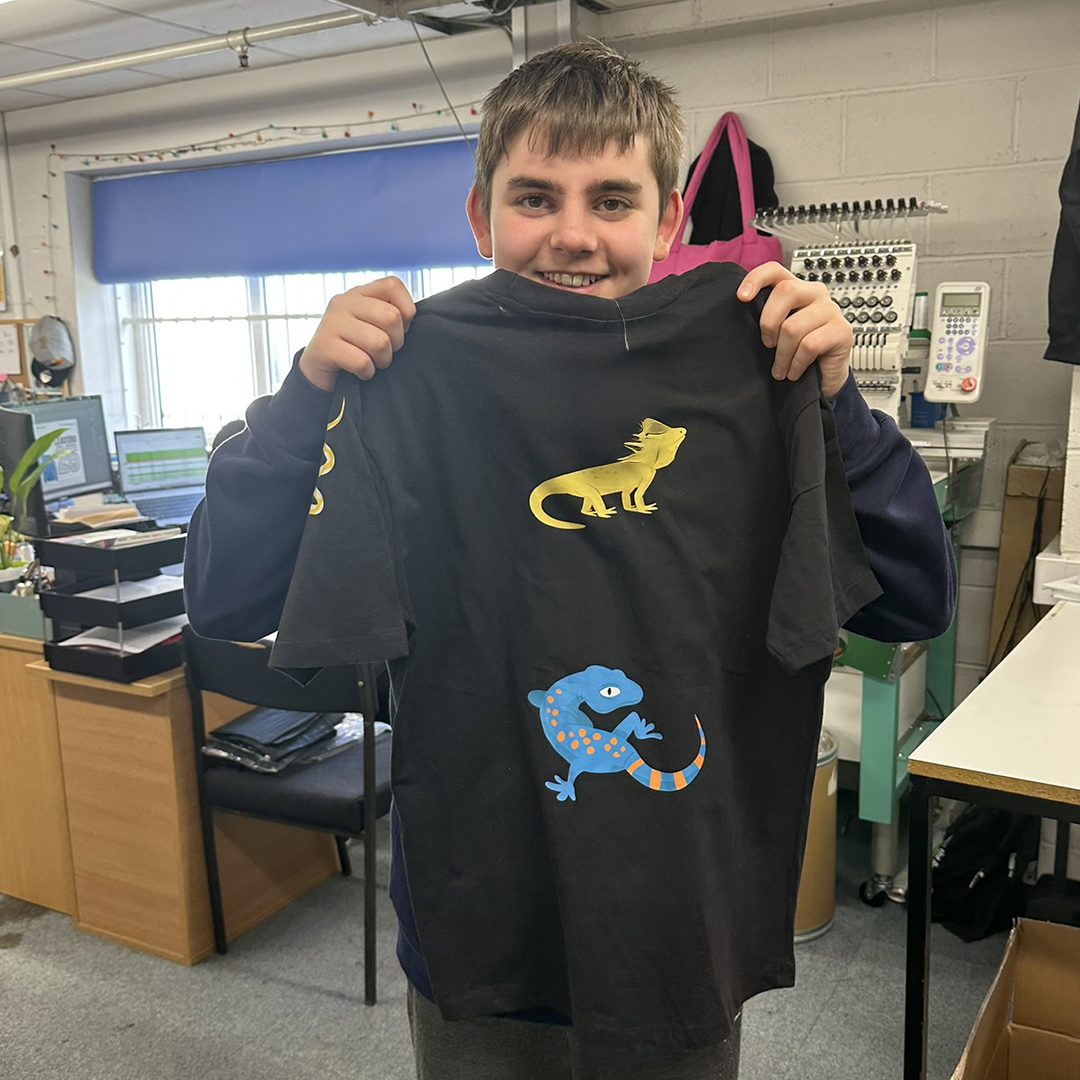 Student holding lizard design