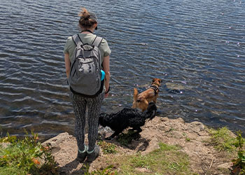Kayleigh and dogs next to water