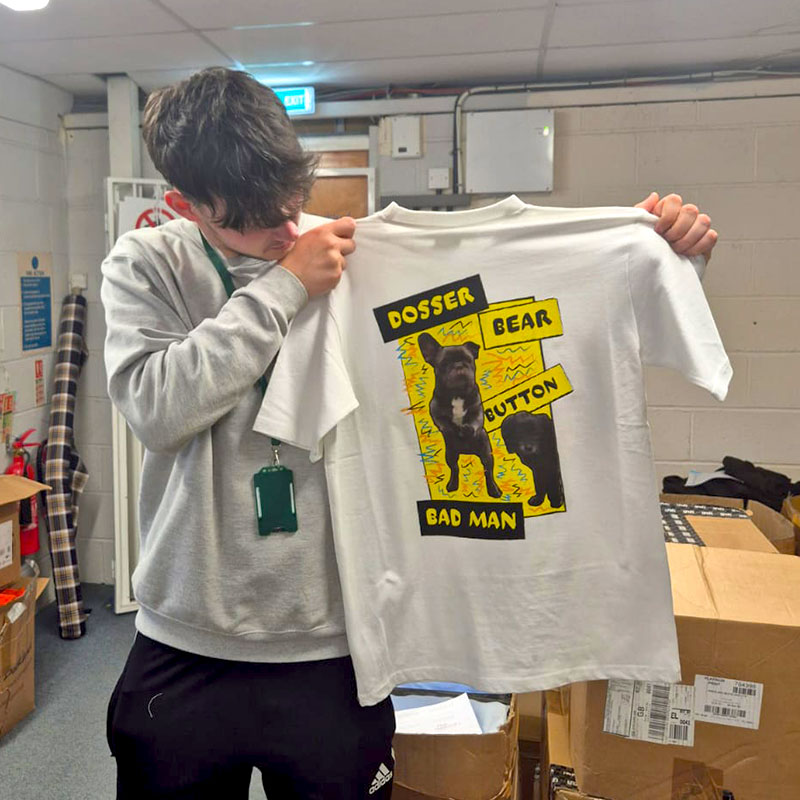 Student holding up t-shirt design