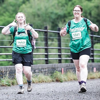 Carla and Megan walking across a bridge