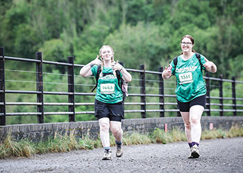 Two of the P & B trailblazers giving thumbs up while walking