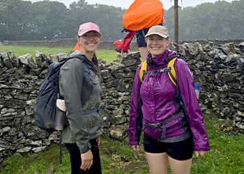 Hannah and Rachel in front of stone wall