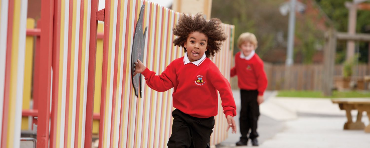 child running alongside fence