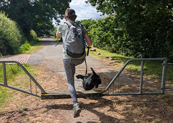 Kayleigh and dog jumping a gate